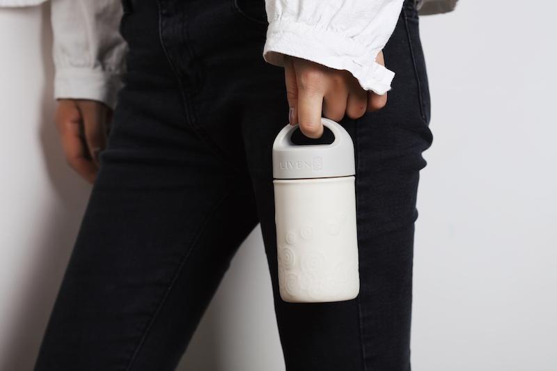 Liven Destiny Travel Mug featuring a tourmaline ceramic body, silicone cover, and convenient carrying handle, perfect for on-the-go hydration.