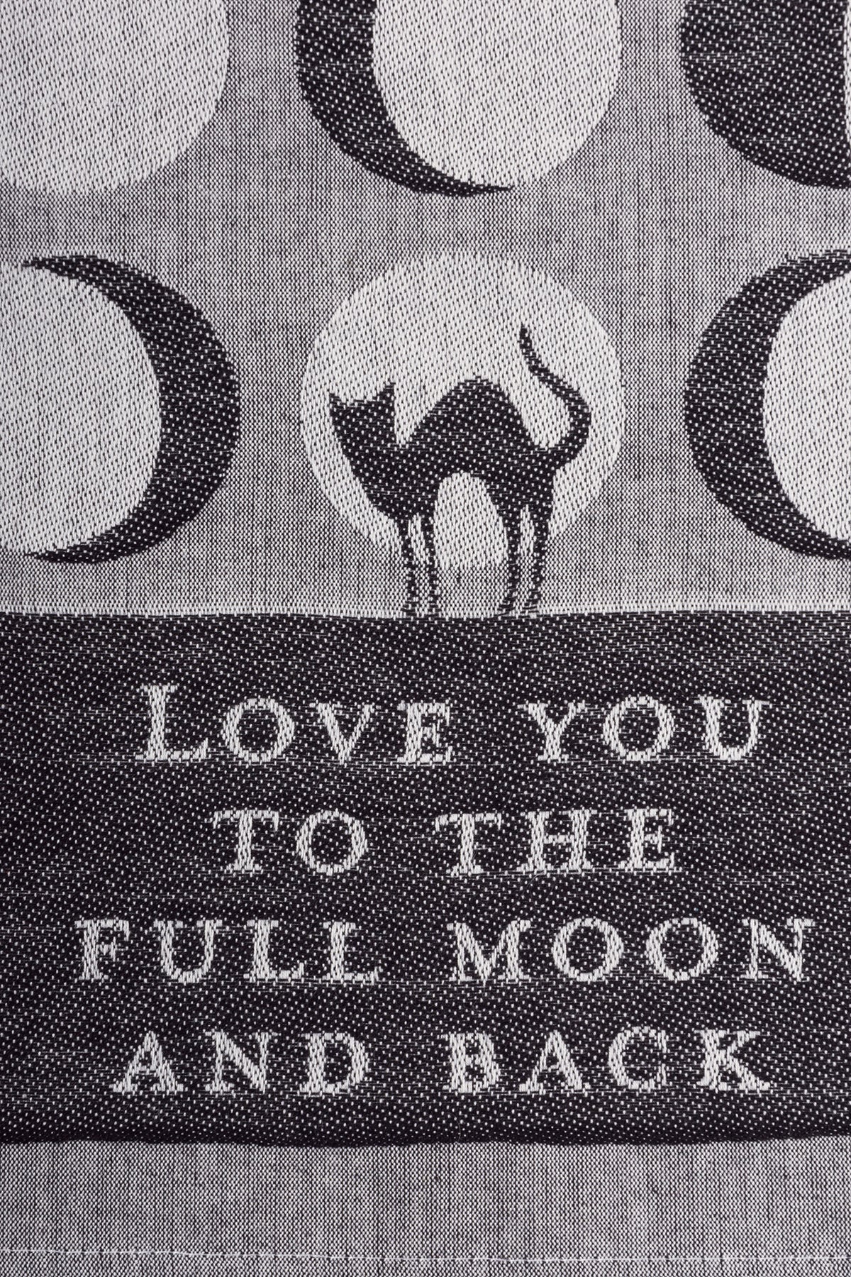 A jacquard woven kitchen towel featuring a cat silhouette and moon phase designs with the phrase 'Love You To The Full Moon And Back'.