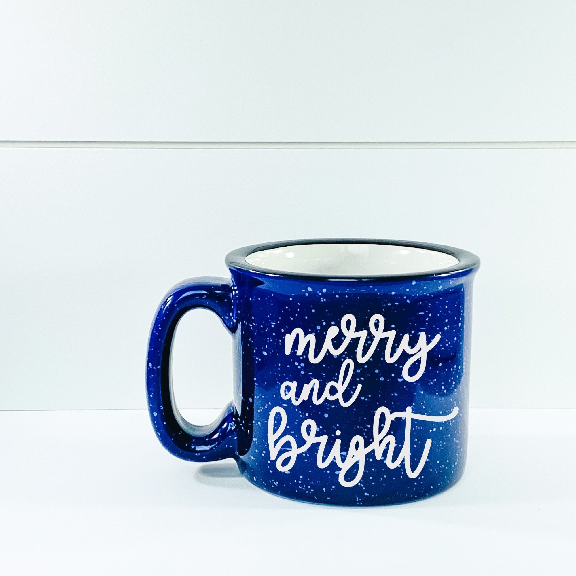 Merry And Bright Campfire Mug with vibrant design, perfect for cozy beverages.