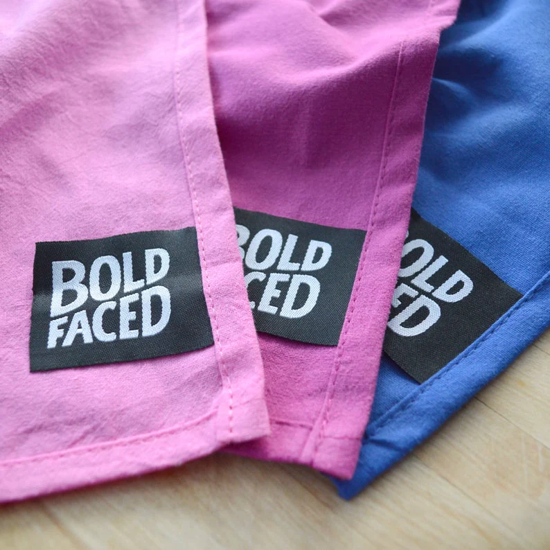 Missy Elliott-inspired cotton tea towel with the phrase 'Go, get your dry on' screen-printed in vibrant colors, hanging on a kitchen rack.