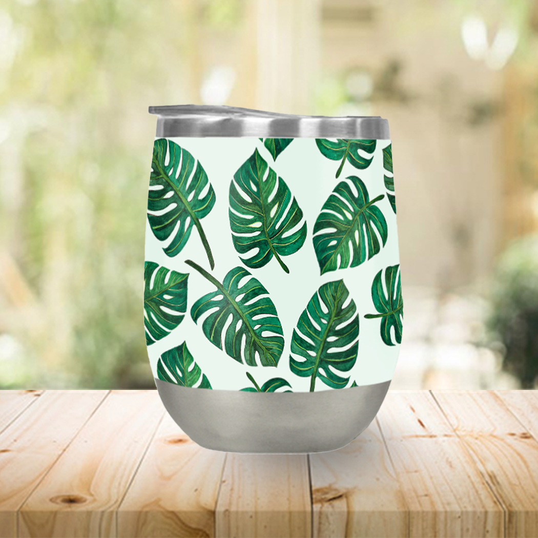 Monstera Watercolor Stemless Wine Tumbler showcasing vibrant tropical design and stainless steel construction.