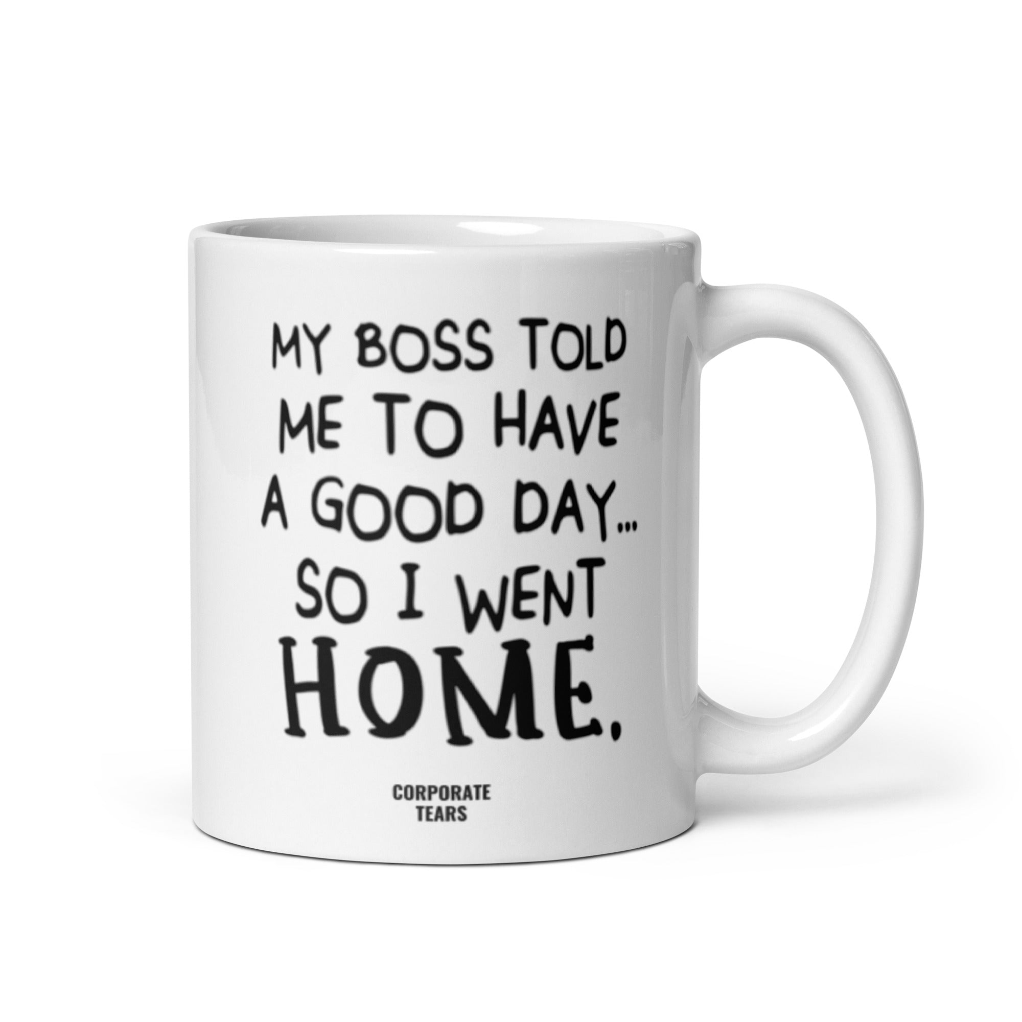 A humorous ceramic mug with the quote 'My Boss Told Me To Have A Good Day So I Went Home' printed on both sides, showcasing its glossy finish.