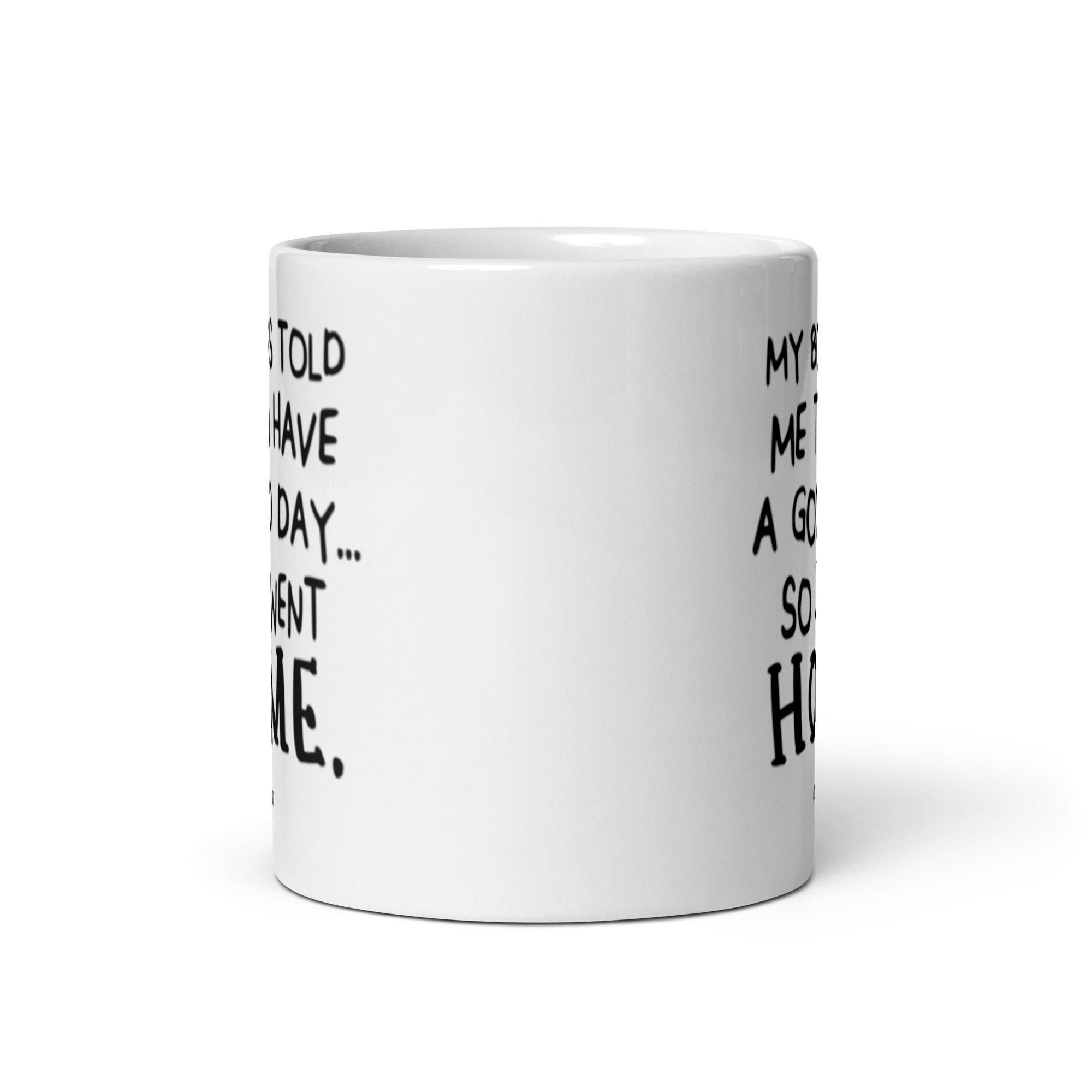 A humorous ceramic mug with the quote 'My Boss Told Me To Have A Good Day So I Went Home' printed on both sides, showcasing its glossy finish.