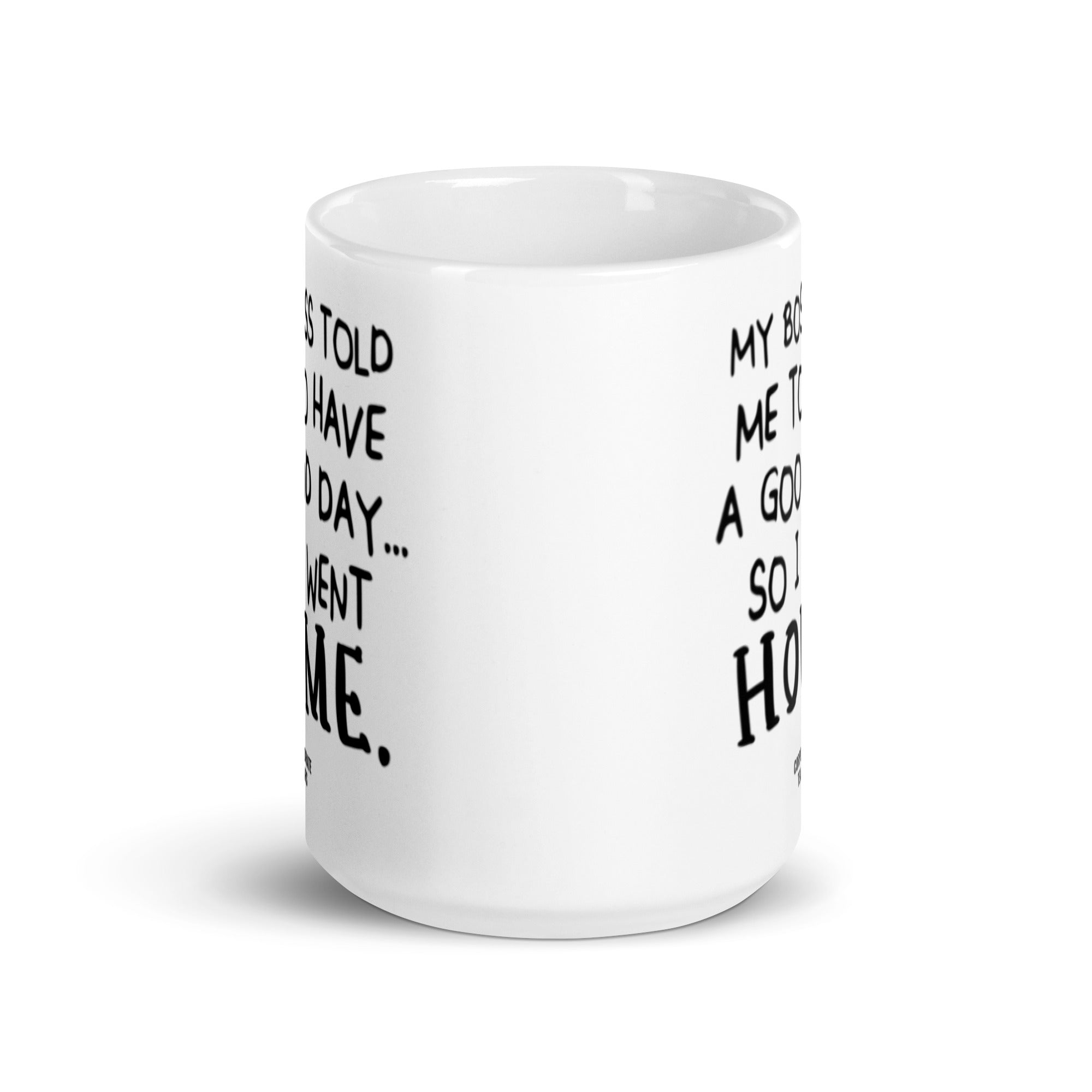 A humorous ceramic mug with the quote 'My Boss Told Me To Have A Good Day So I Went Home' printed on both sides, showcasing its glossy finish.