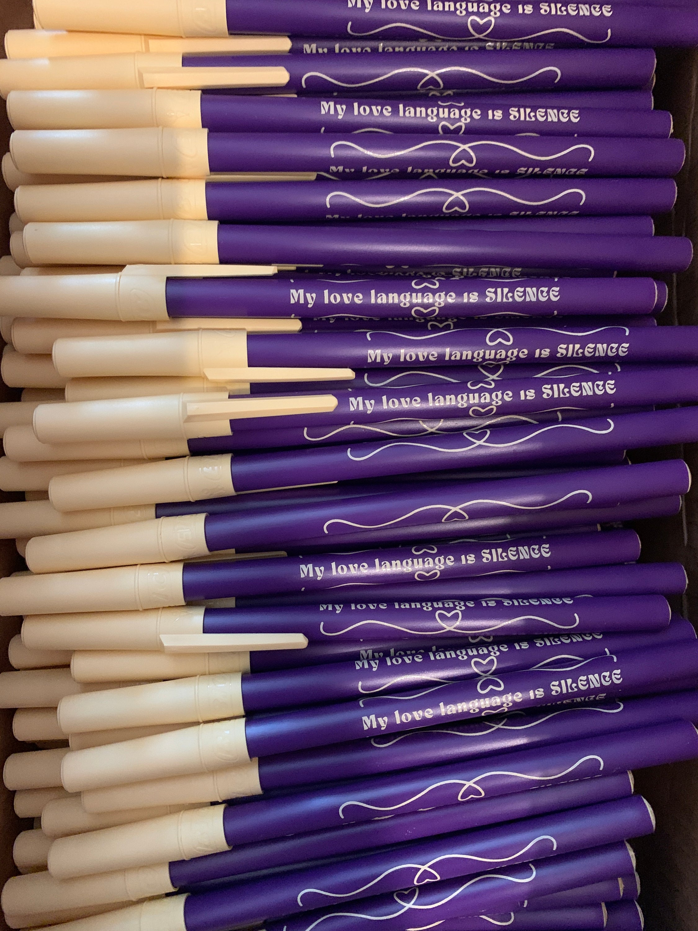 Violet ballpoint pen with fine point and blue ink, featuring the phrase 'My Love Language Is Silence'.