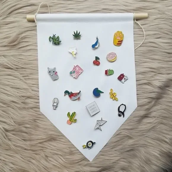 A colorful assortment of 20 mystery enamel pins displayed on a sturdy hanging banner, showcasing various designs and brands.