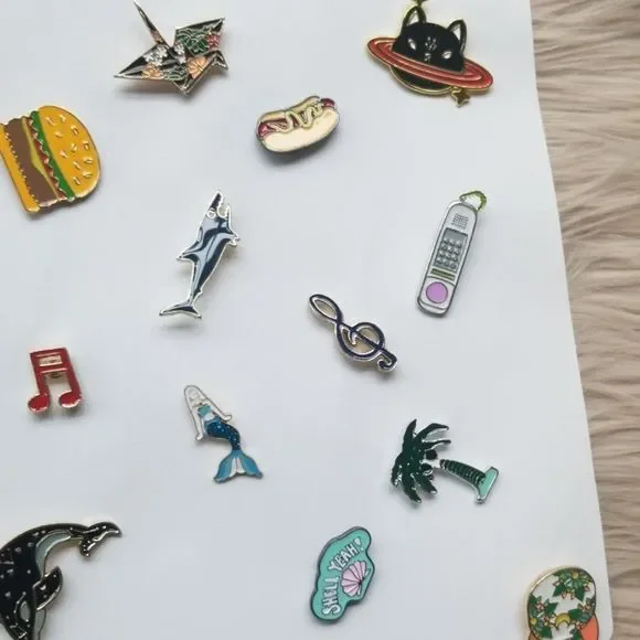 A colorful assortment of 20 mystery enamel pins displayed on a sturdy hanging banner, showcasing various designs and brands.