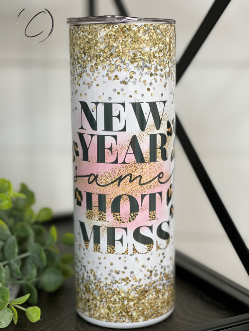 A stylish 20oz skinny tumbler featuring the phrase 'New Year Same Hot Mess' with a vibrant full wrap design, perfect for hot and cold beverages.
