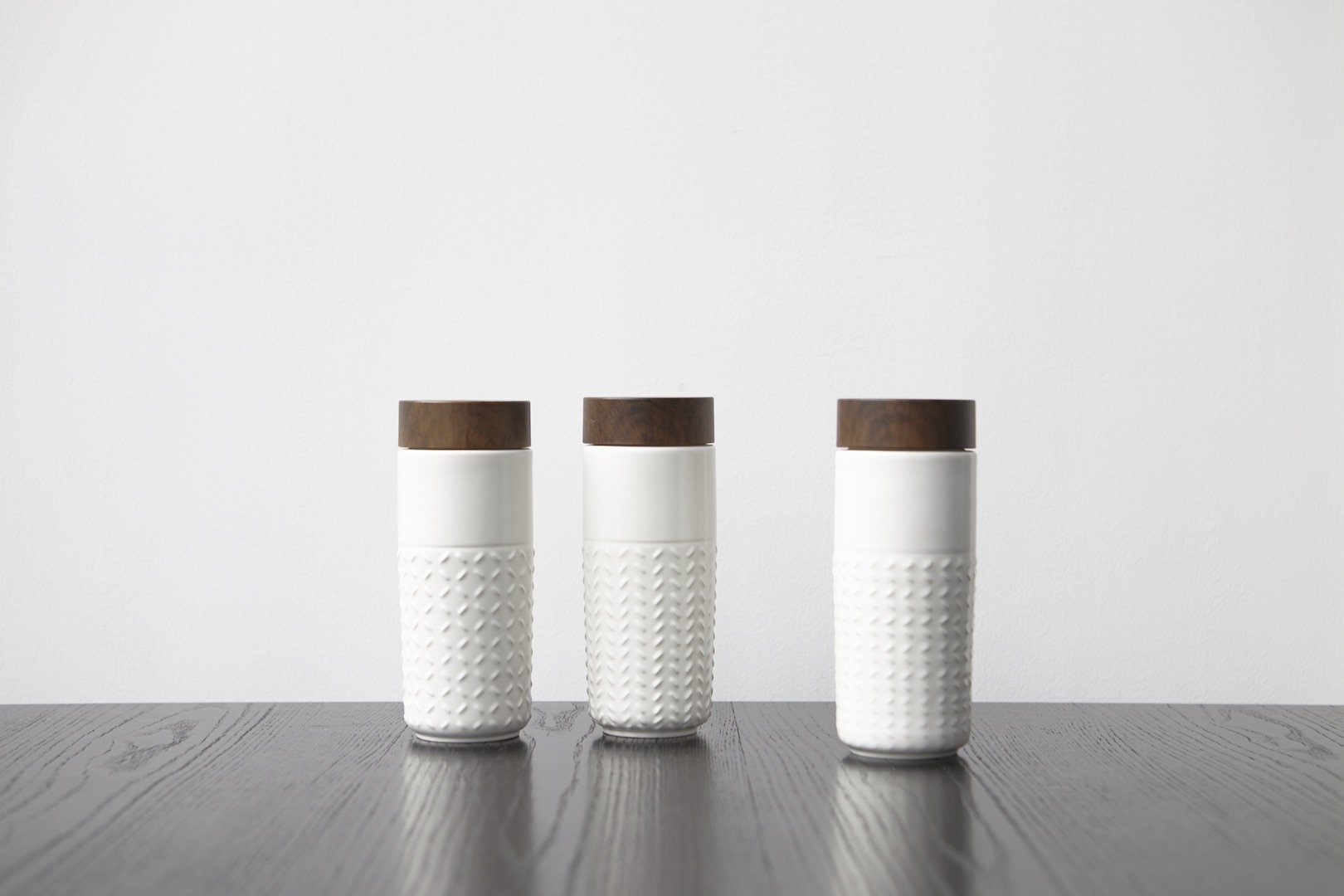 One-O-One Flying to the Clouds Tumbler showcasing its embossed checkered design, available in six trendy colors with a walnut wood-effect lid.