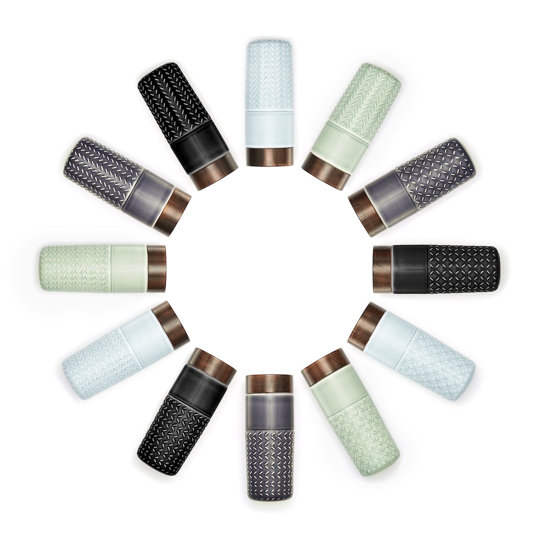 One-O-One Free Soaring Ceramic Tumbler showcasing its elegant design with raised starburst texture and walnut wood-effect lid.