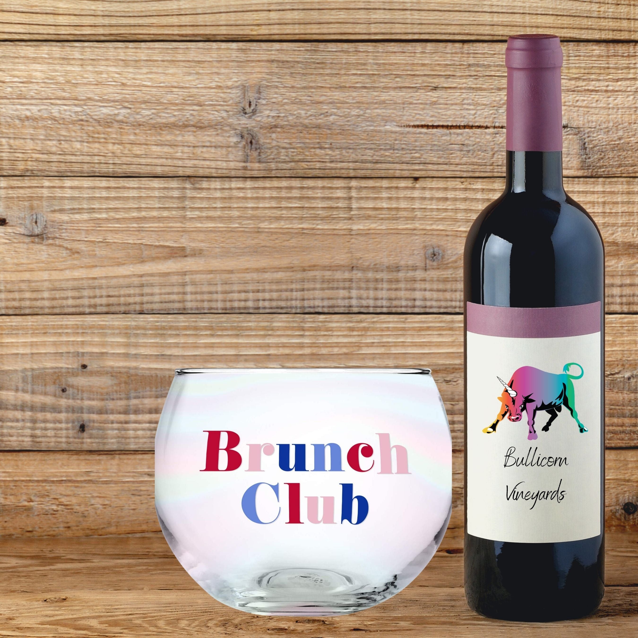 A set of six clear glass roly poly cocktail glasses with colorful 'Brunch Club' lettering, perfect for brunch gatherings.