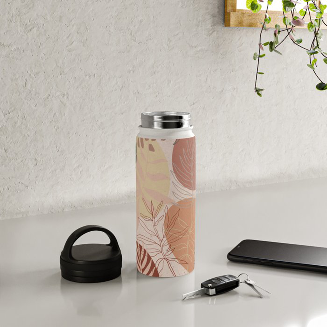 Pink terracotta stainless steel water bottle with a handle lid, showcasing its sleek design and durable material.