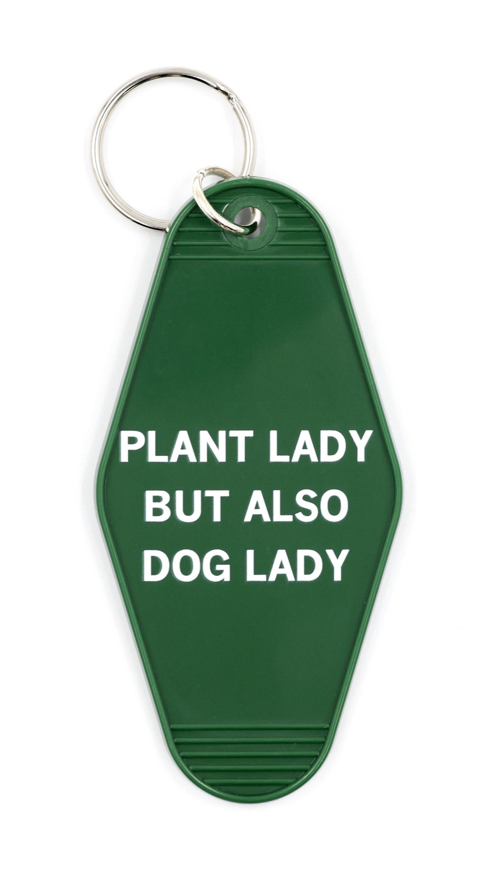 Green motel-style keychain with white lettering saying 'PLANT LADY BUT ALSO DOG LADY', featuring a split ring attachment.