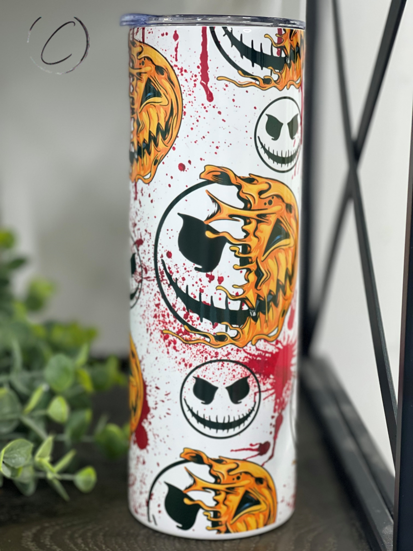 Pumpkin Jack 20oz Skinny Tumbler with vibrant design and reusable straw, perfect for hot and cold beverages.