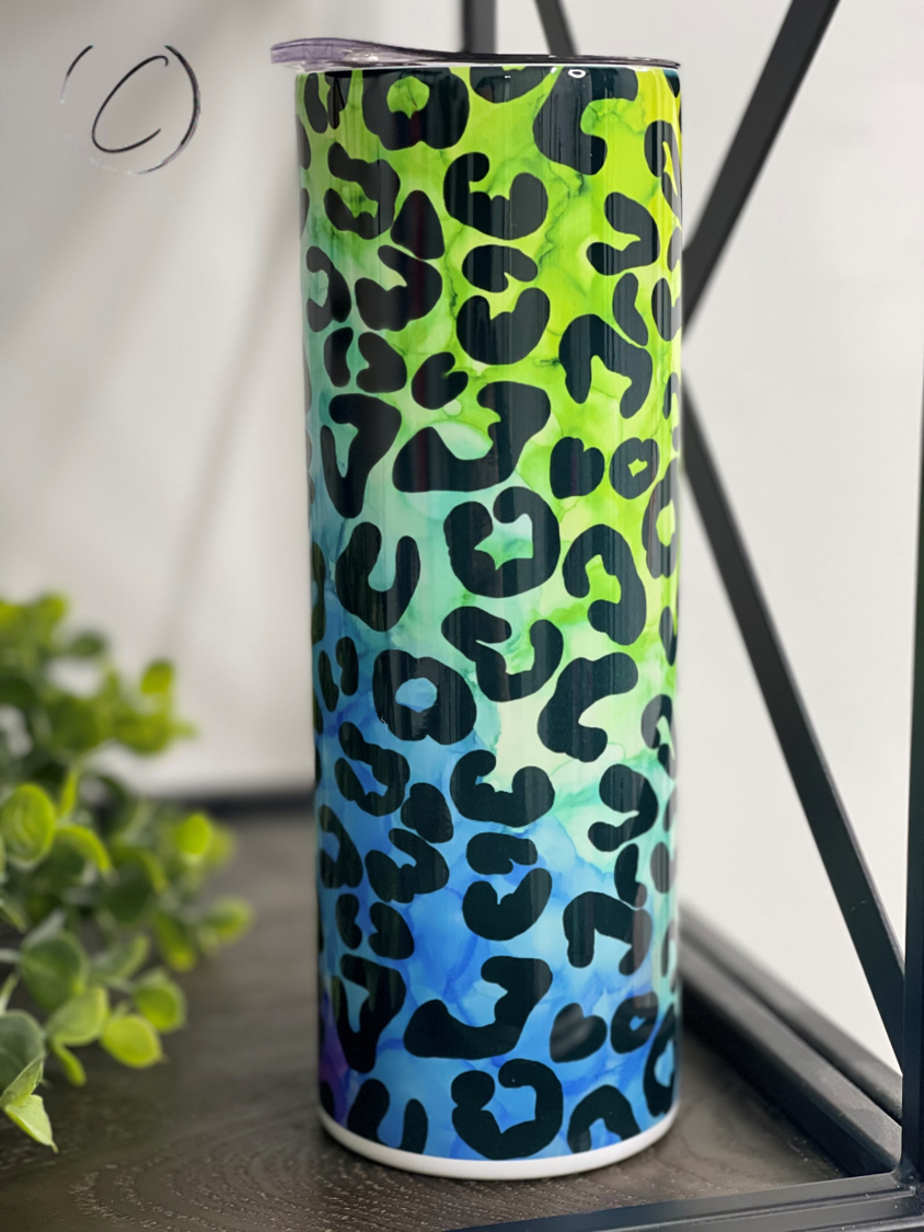 Rainbow Leopard 20oz Skinny Tumbler featuring a vibrant leopard print design, perfect for hot and cold beverages.