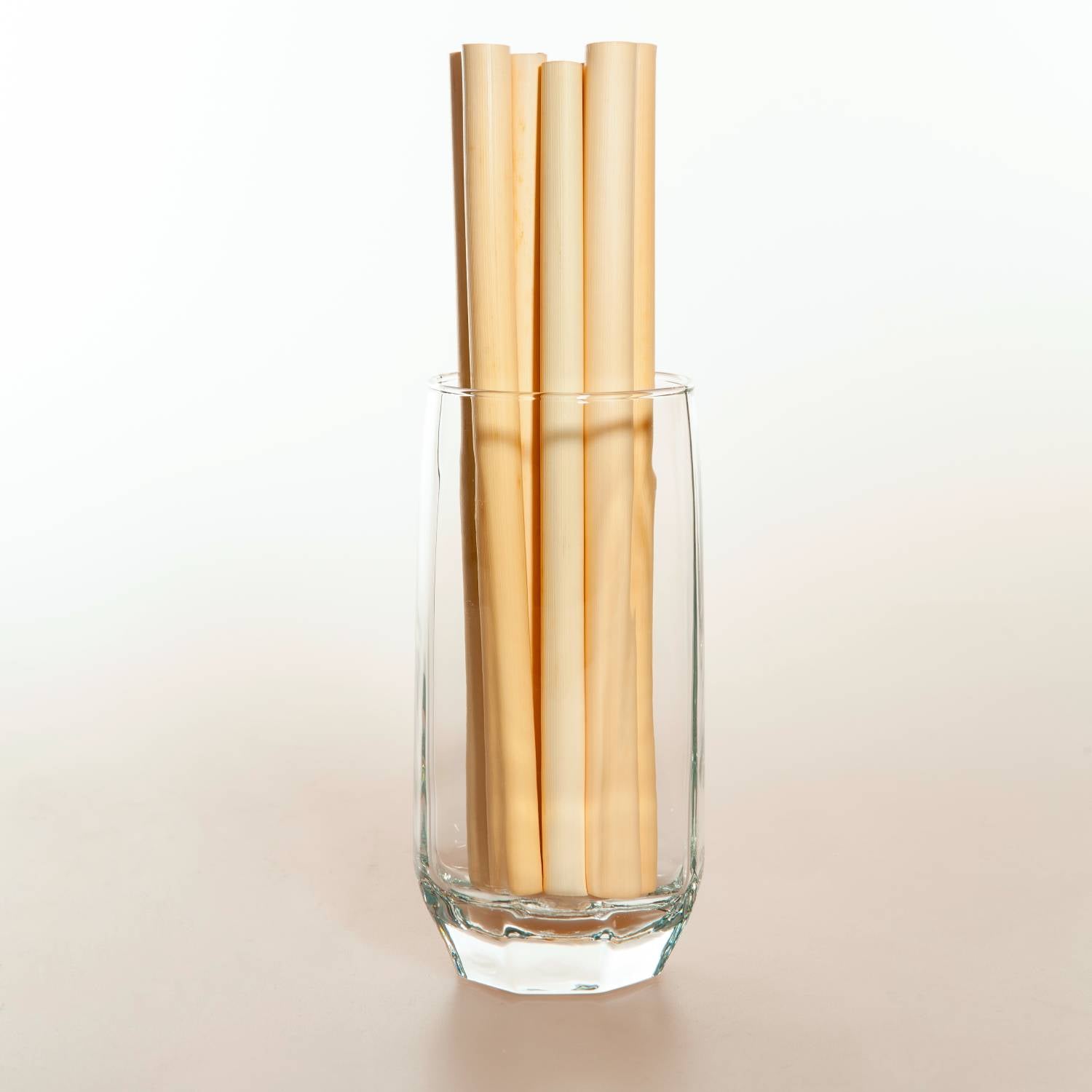 A bundle of large reed straws, showcasing their natural beige color and eco-friendly design, ideal for smoothies and beverages.