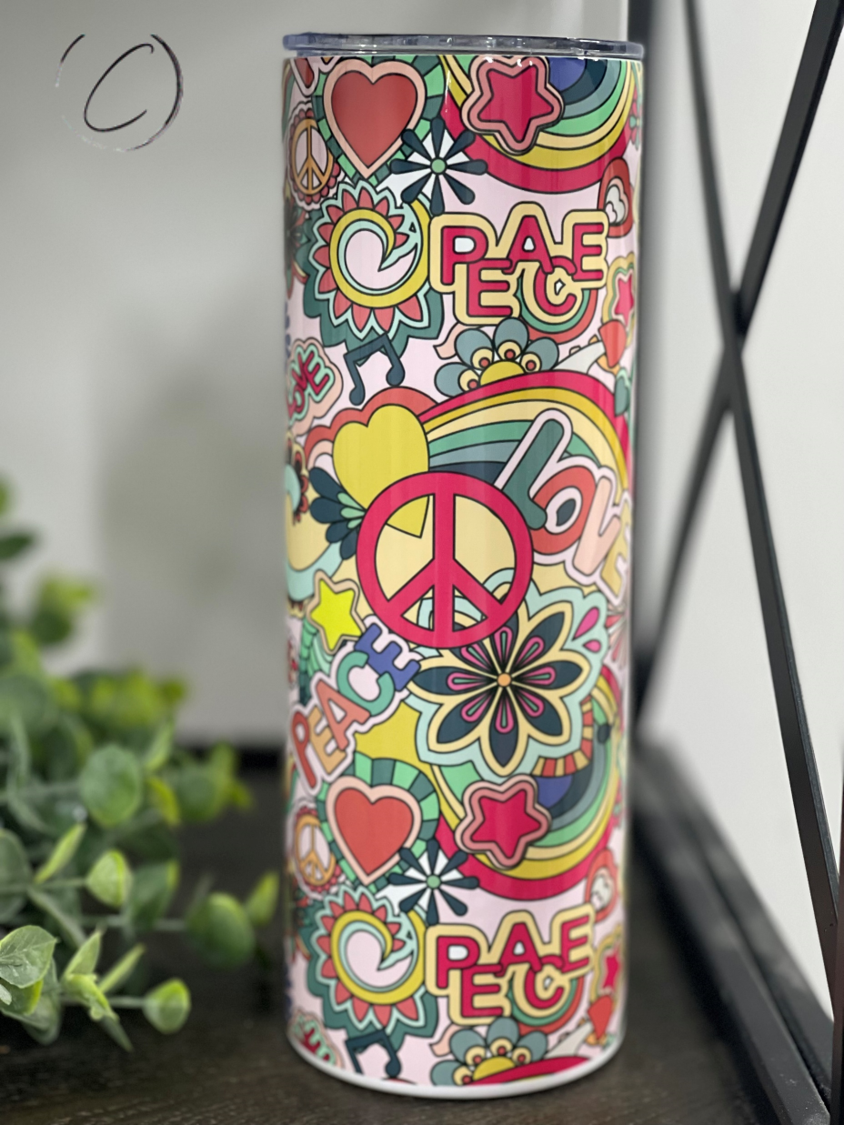 A colorful 20oz skinny tumbler featuring a retro peace and love design, complete with a reusable straw.