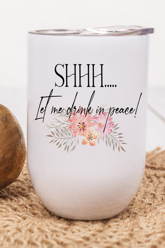 A stainless steel floral wine tumbler with a lid and straw, featuring a vibrant 'Shhh Let Me Drink In Peace' design.
