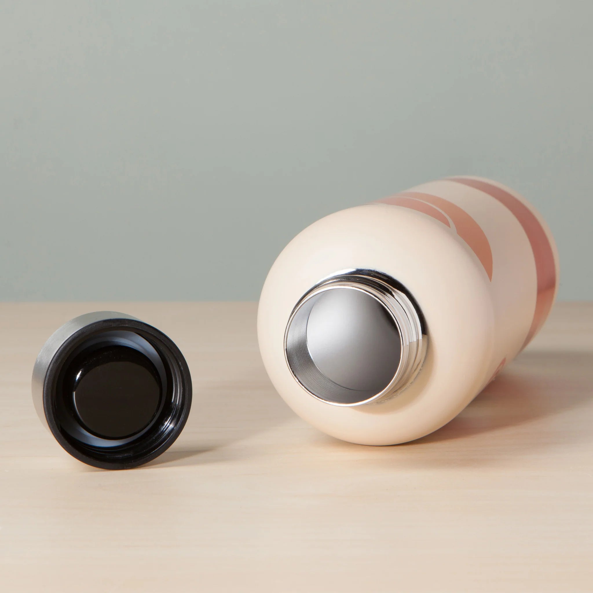 Solstice Hydration Stainless Steel Water Bottle with botanical design in a gift tube, showcasing abstract blossoms and delicate leaves.