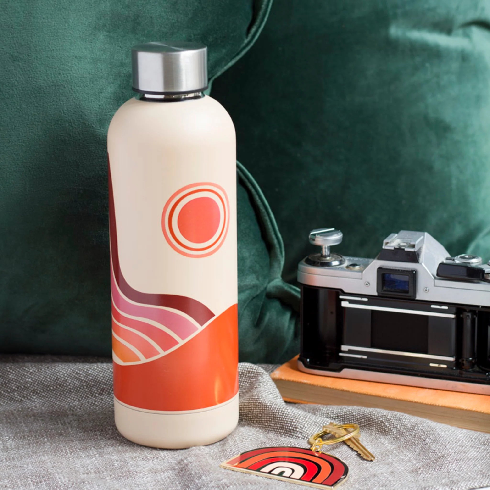 Solstice Hydration Stainless Steel Water Bottle with botanical design in a gift tube, showcasing abstract blossoms and delicate leaves.