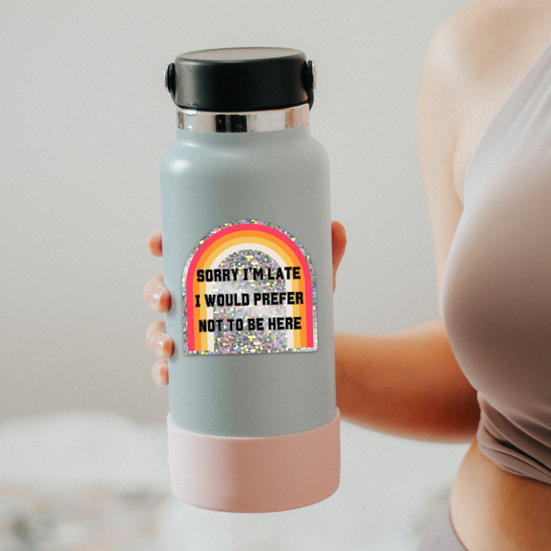 Glitter sticker with the text 'Sorry I'm Late I Would Prefer Not To Be Here', showcasing a humorous design.