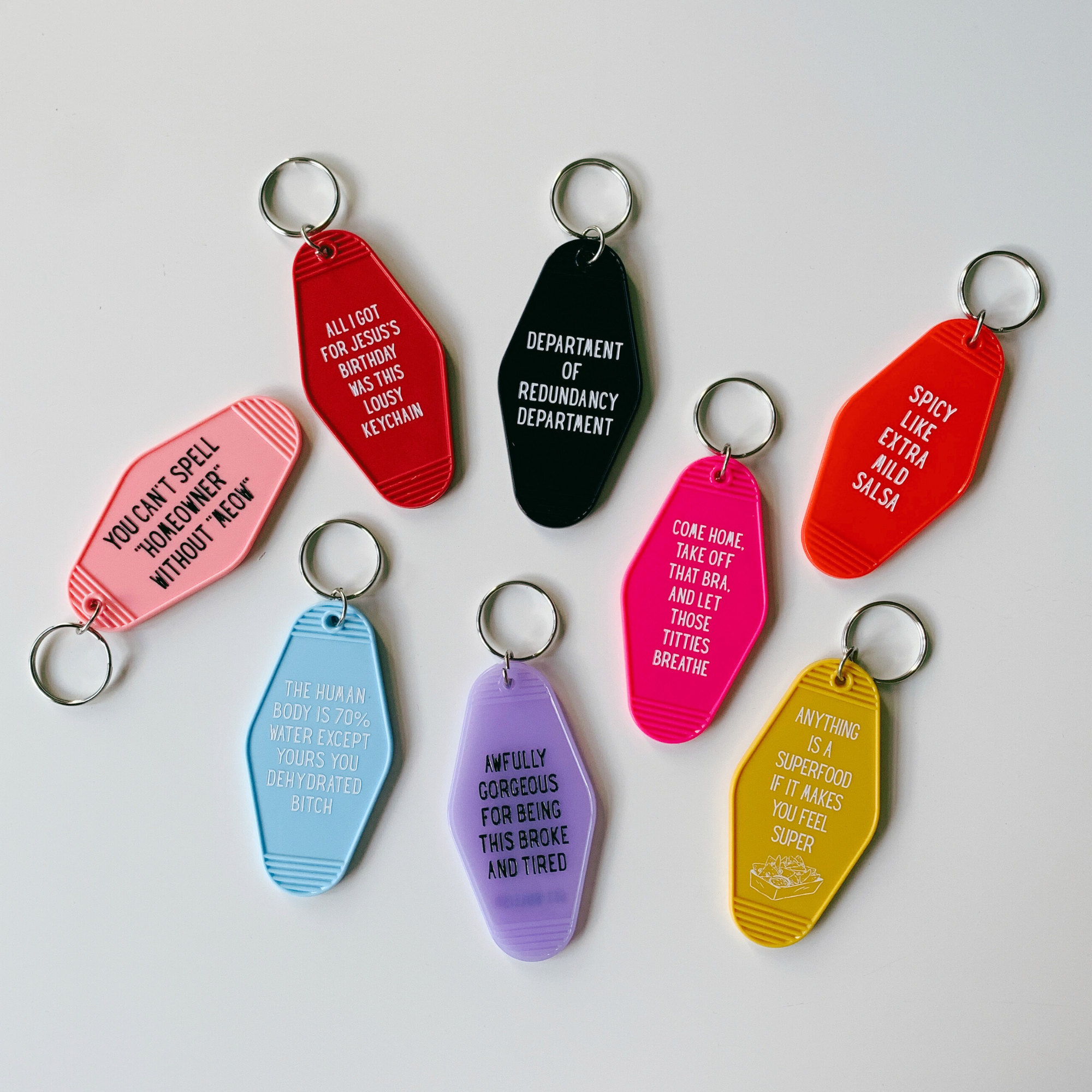 Red keychain with 'SPICY LIKE EXTRA MILD SALSA' in motel style design, featuring a split ring for keys.