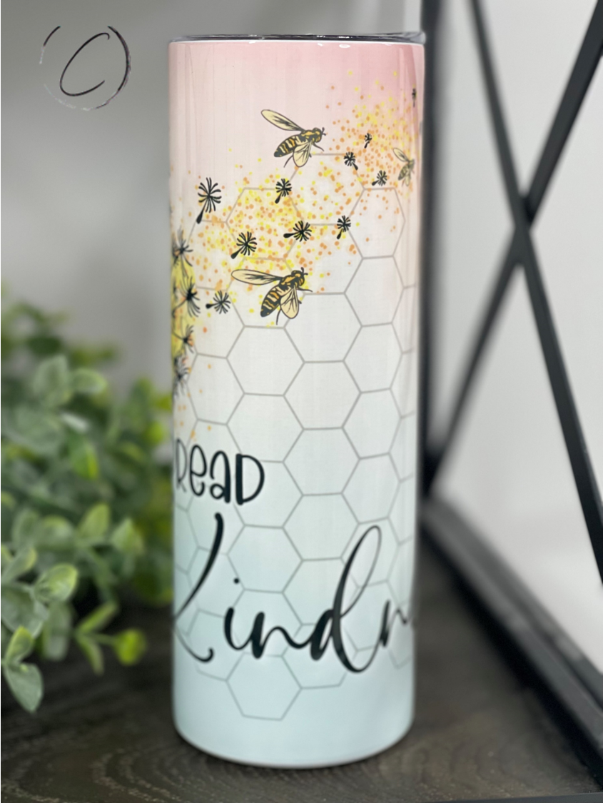 A stylish 20oz skinny tumbler with a vibrant 'Spread Kindness' design, featuring a reusable straw and a durable, high-quality finish.