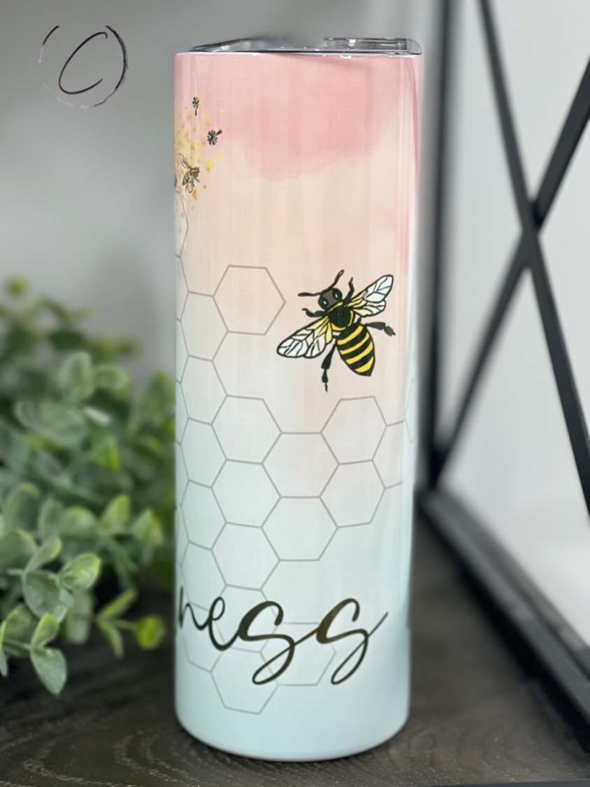 A stylish 20oz skinny tumbler with a vibrant 'Spread Kindness' design, featuring a reusable straw and a durable, high-quality finish.