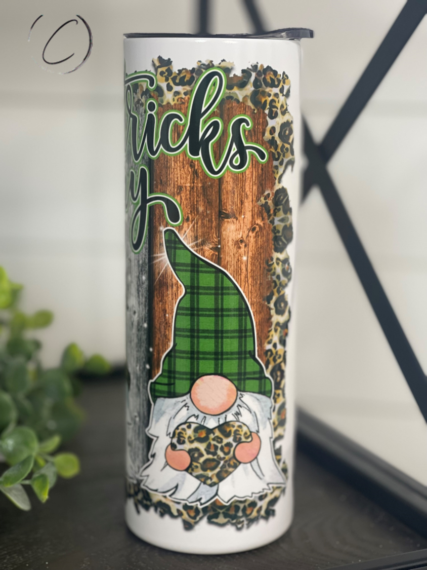 A 20oz skinny tumbler featuring festive St. Patrick's Day gnomes, designed for durability and includes a reusable straw.