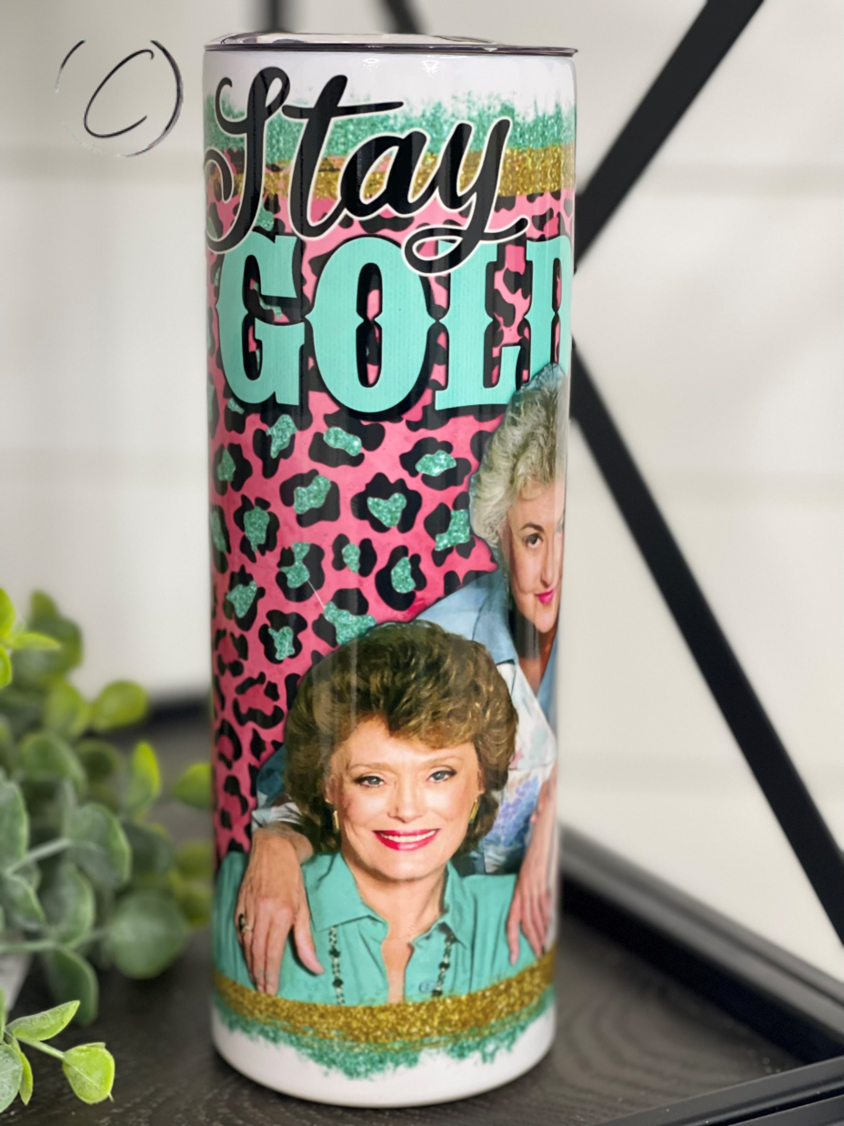 Stay Golden 20oz Skinny Tumbler with a stylish design, perfect for hot and cold drinks, featuring a reusable straw.