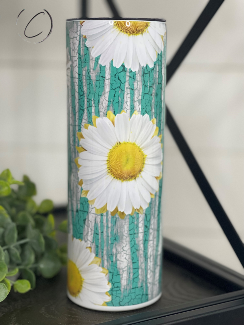 Teal Crackle Daisies 20oz Skinny Tumbler with a vibrant floral design, showcasing its durable construction and included straw.