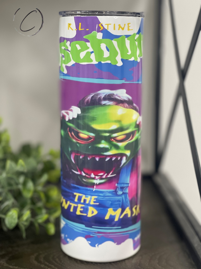 The Haunted Mask 20oz Skinny Tumbler featuring a spooky design, perfect for Halloween lovers.