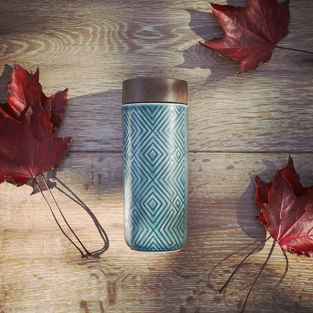 The Miracle Ceramic Tumbler showcasing its elegant design with a bamboo effect lid, featuring a tourmaline lining for enhanced beverage purity.