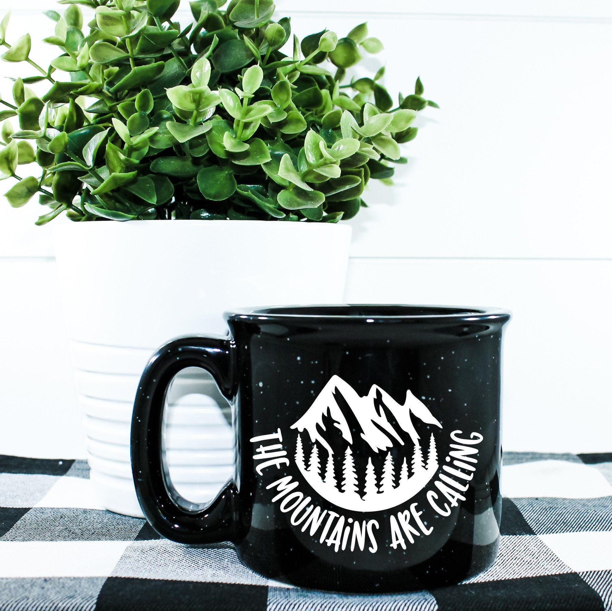 Ceramic campfire mug with 'The Mountains Are Calling And I Must Go' design, perfect for outdoor enthusiasts.