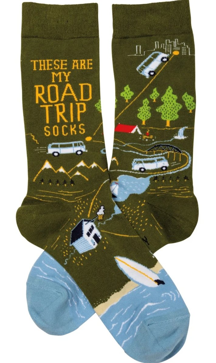 Colorful socks with 'These Are My Road Trip Socks' text and travel-themed designs, perfect for travel lovers.