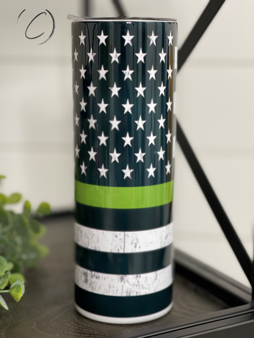 Thin Green Line 20oz Skinny Tumbler with a full wrap design, featuring a durable construction and a reusable straw.