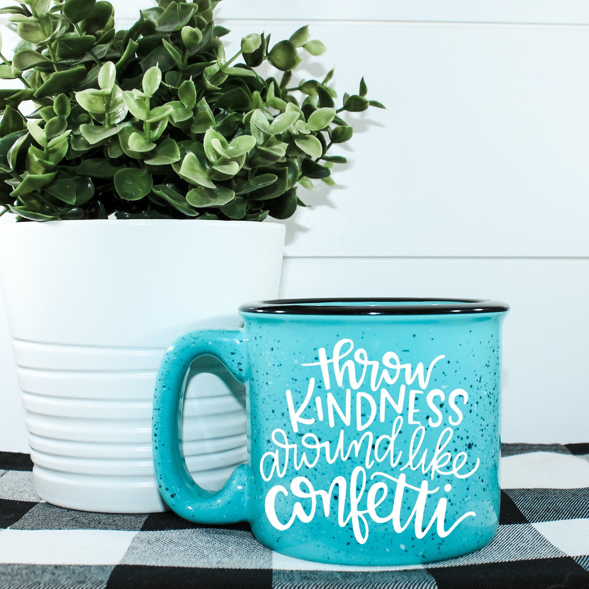 Ceramic campfire mug with 'Throw Kindness Around Like Confetti' design, perfect for cozy beverages.