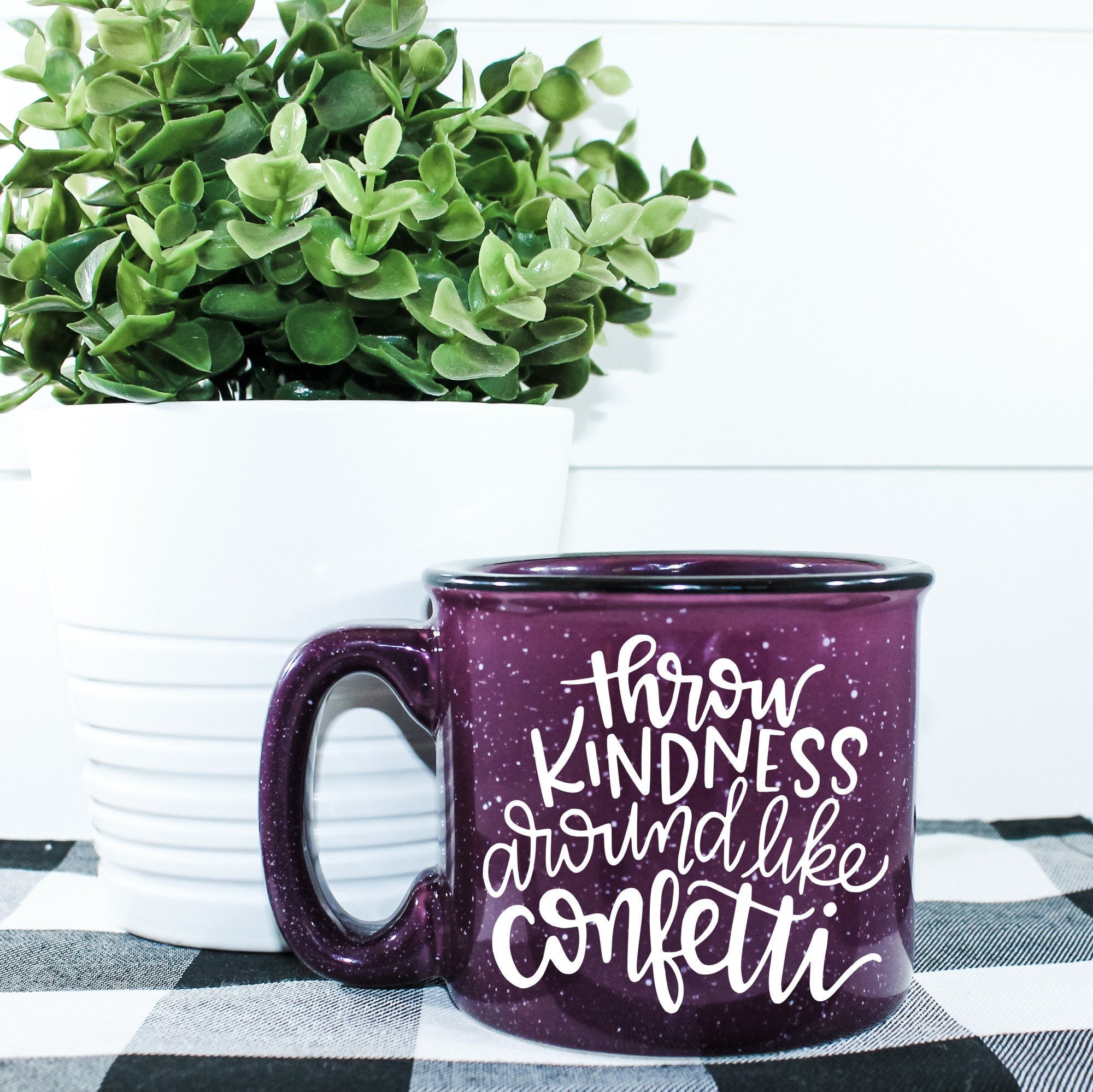 Ceramic campfire mug with 'Throw Kindness Around Like Confetti' design, perfect for cozy beverages.