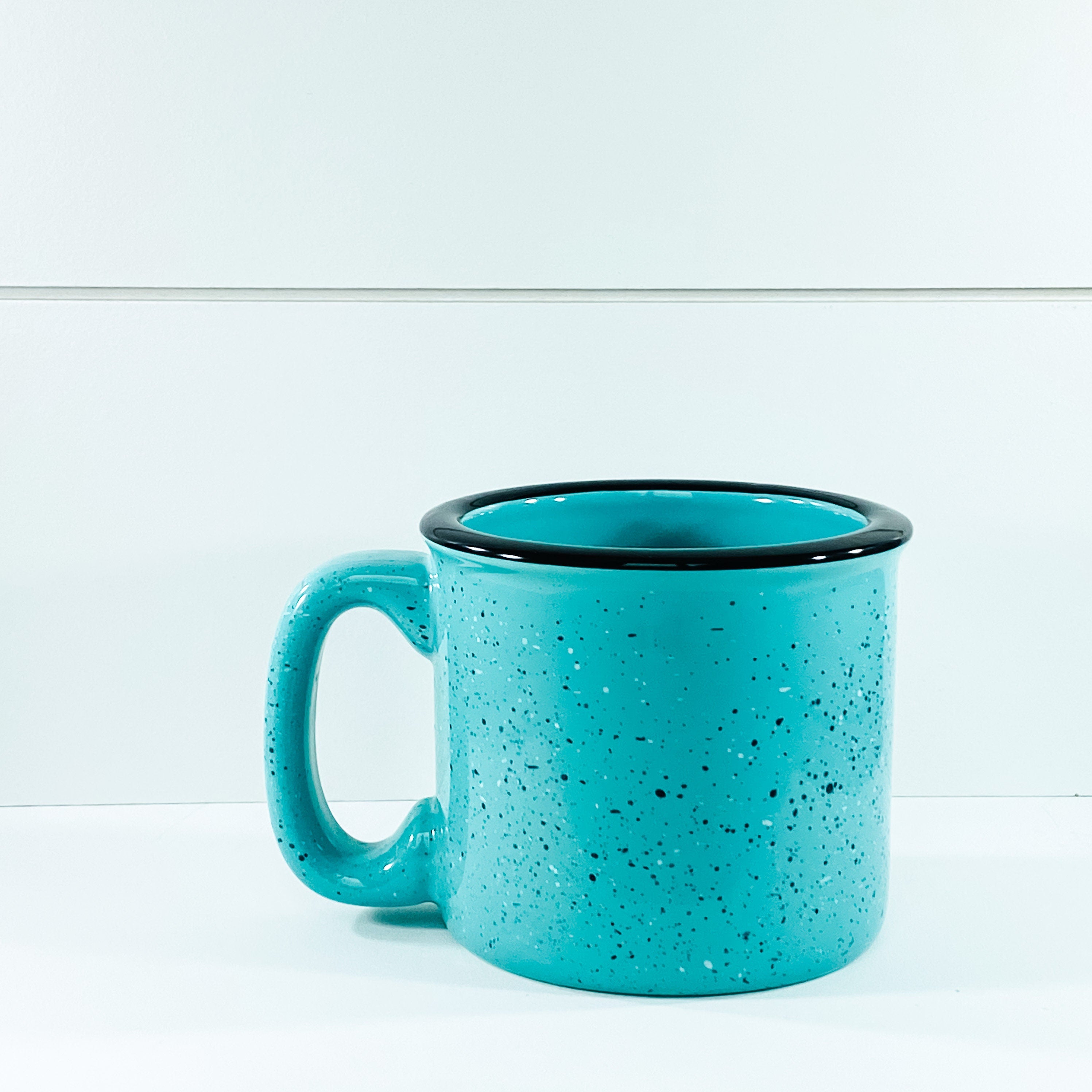 Ceramic campfire mug with 'Throw Kindness Around Like Confetti' design, perfect for cozy beverages.