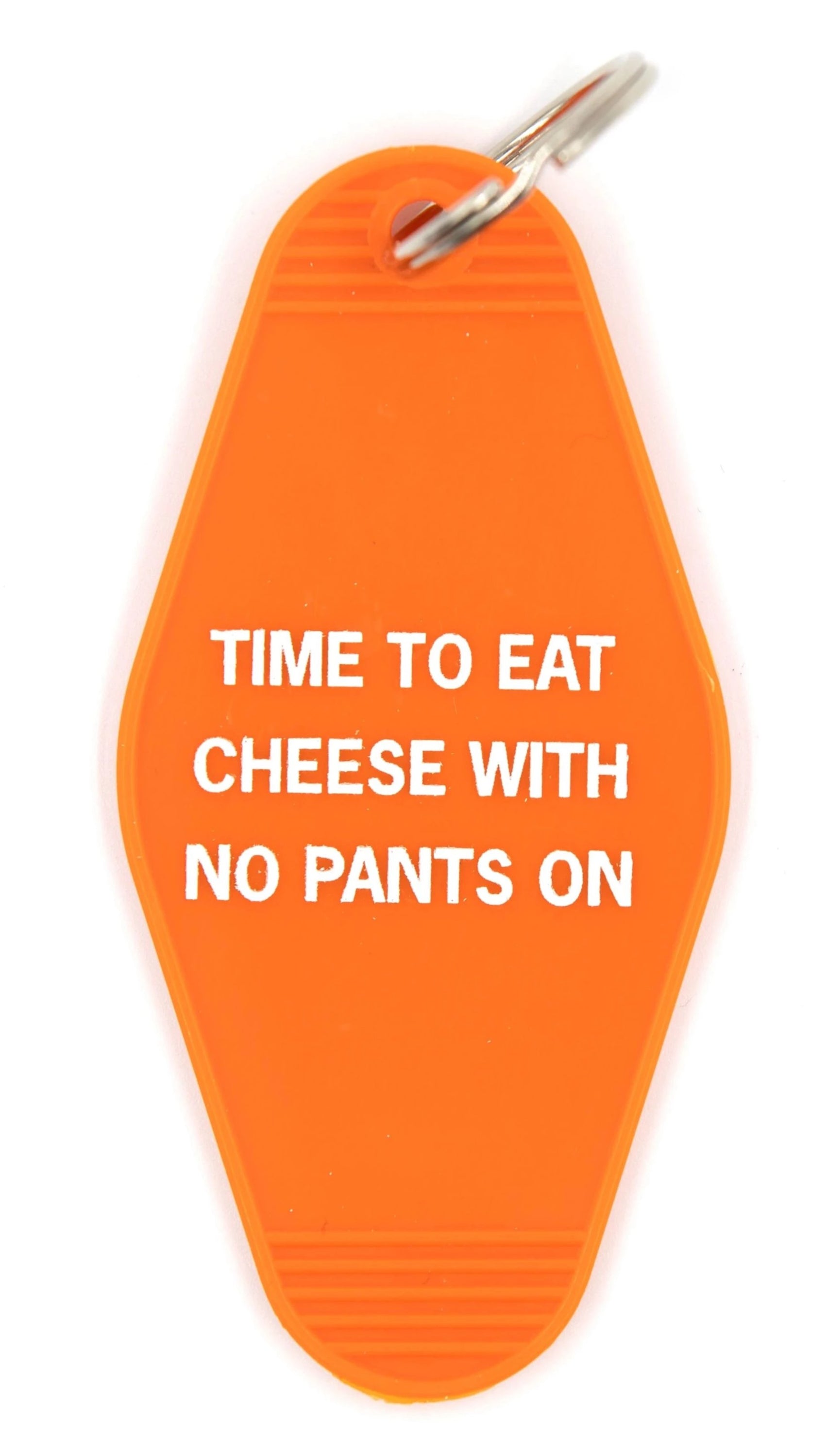 Orange motel-style keychain with white text reading 'TIME TO EAT CHEESE WITH NO PANTS ON', featuring a split ring attachment.
