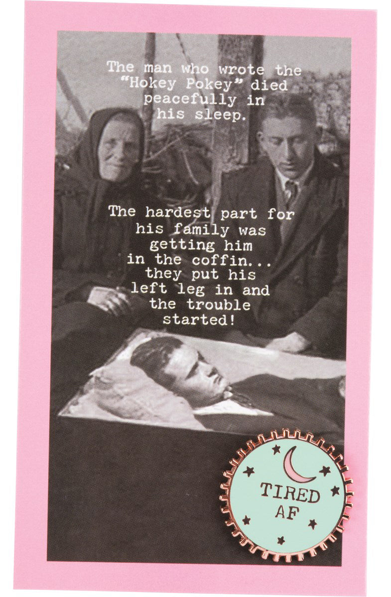 A circular Tired AF enamel pin featuring a moon design with spiked trim, displayed on a vintage photograph gift card.