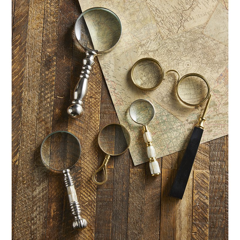 Vintage style magnifying glass with a silver handle, showcasing its elegant design and clear glass lens.