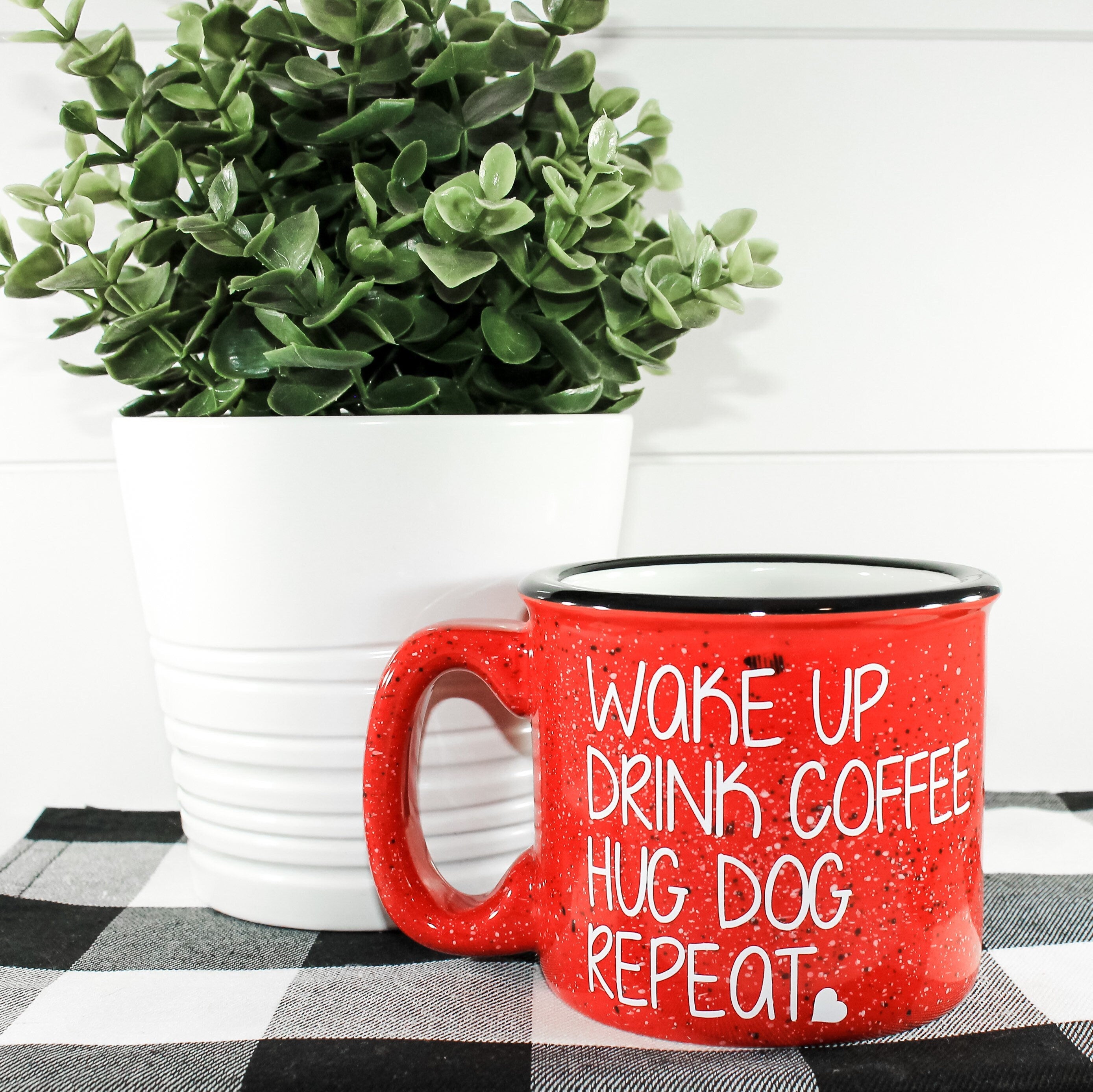 Ceramic campfire mug with the phrase 'Wake Up Drink Coffee Hug Dog Repeat' printed on one side, perfect for dog lovers.