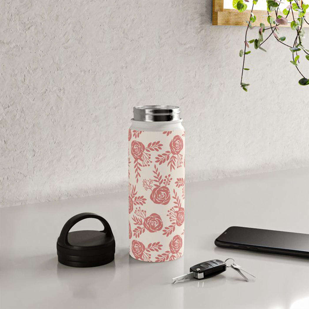 Warm Pink Floral Handle Lid Water Bottle with floral design and stainless steel finish.