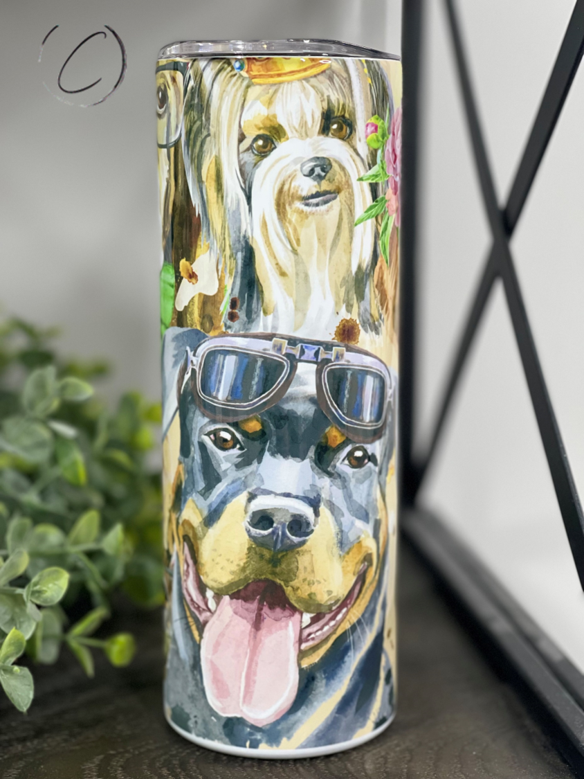 A stylish 20oz skinny tumbler featuring a vibrant watercolor design of various dog breeds, complete with a reusable straw.