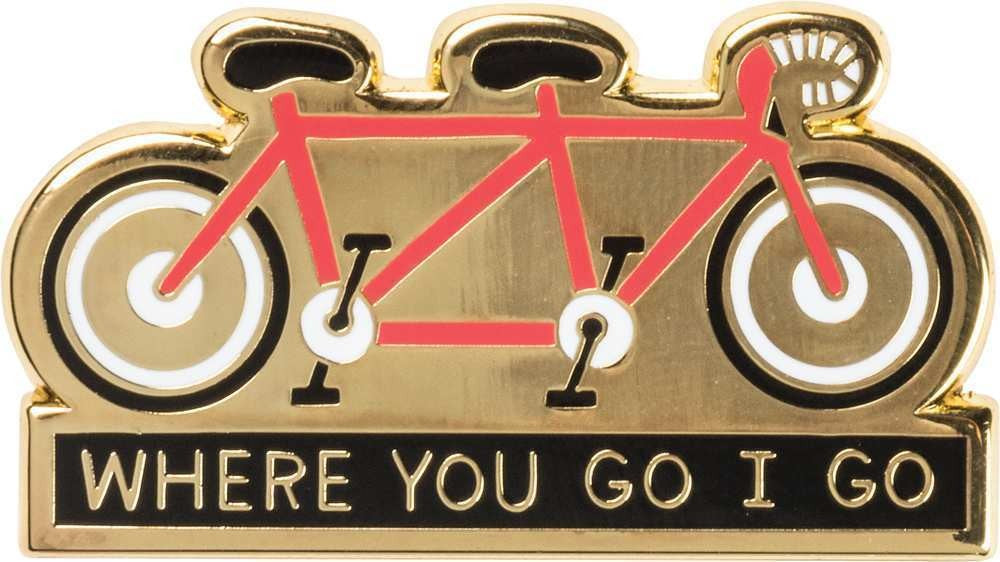 A high-quality enamel pin featuring a tandem bike design with the phrase 'Where You Go I Go - Where You Stay I Stay'.