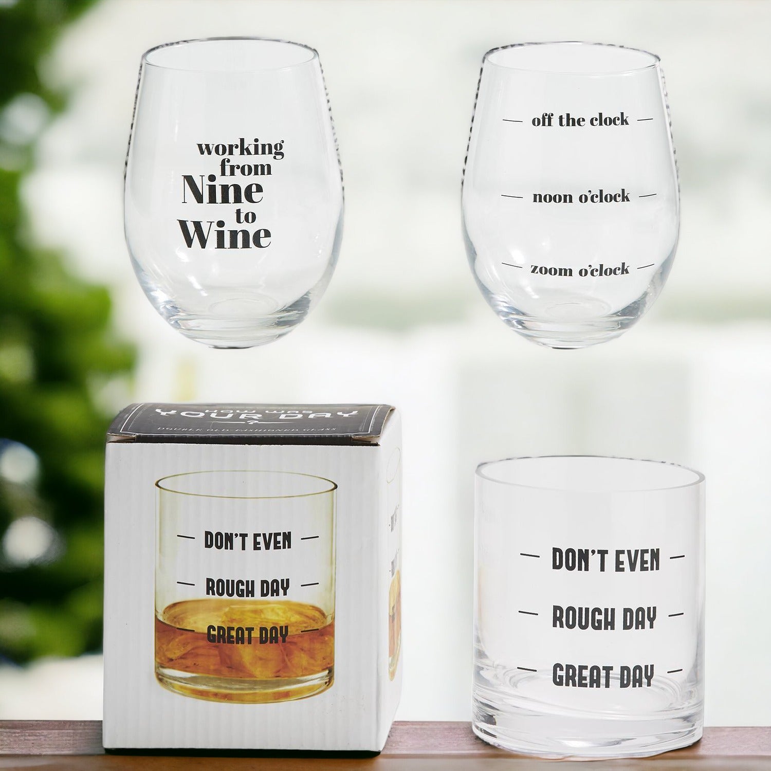 A set of elegant stemless wine and whiskey glasses with witty quotes, beautifully packaged in a decorative gift box.