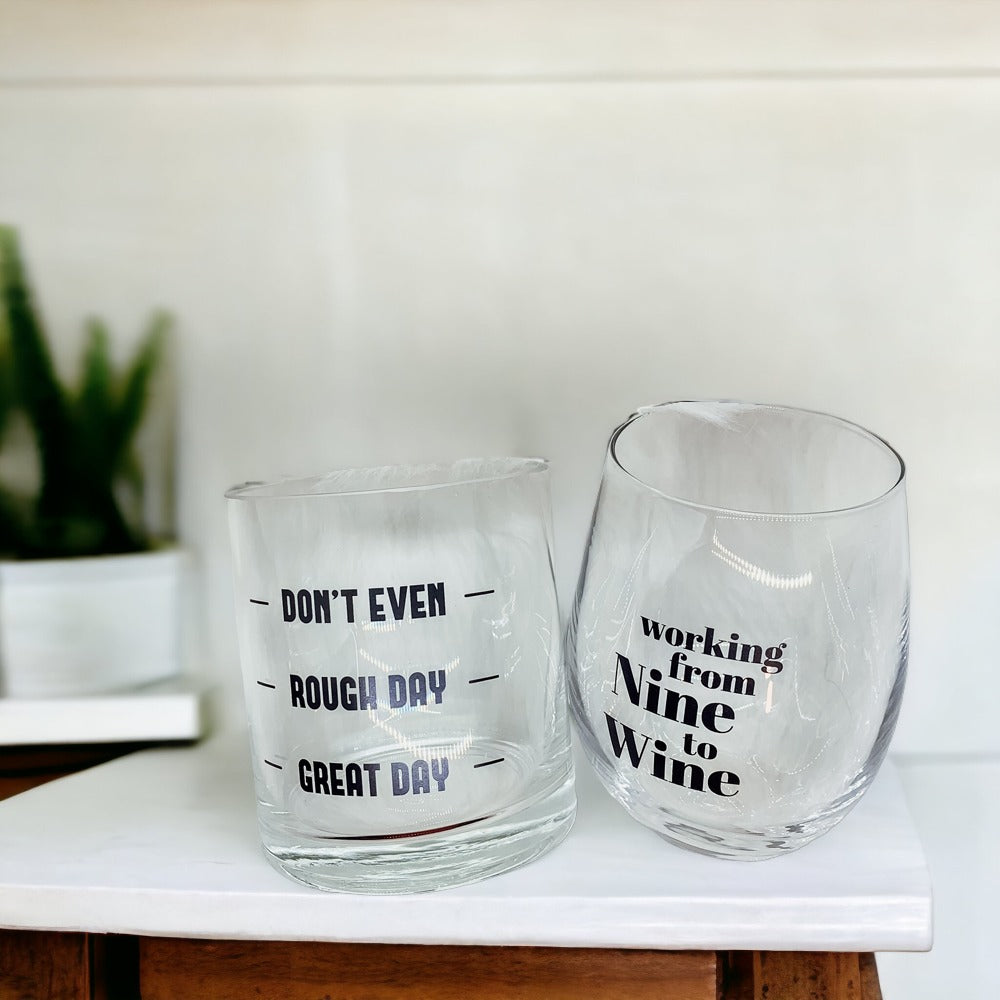 A set of elegant stemless wine and whiskey glasses with witty quotes, beautifully packaged in a decorative gift box.