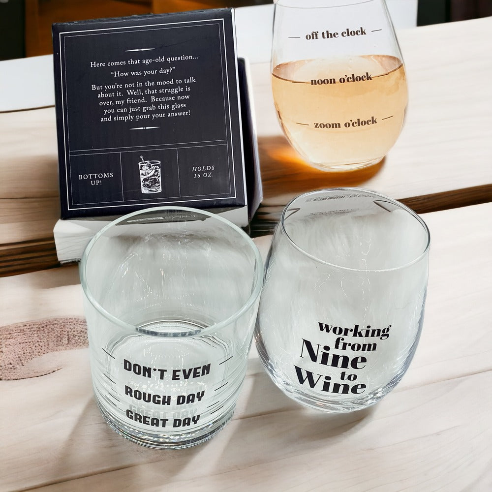 A set of elegant stemless wine and whiskey glasses with witty quotes, beautifully packaged in a decorative gift box.