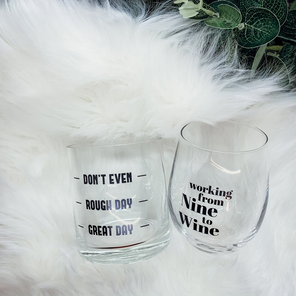 A set of elegant stemless wine and whiskey glasses with witty quotes, beautifully packaged in a decorative gift box.